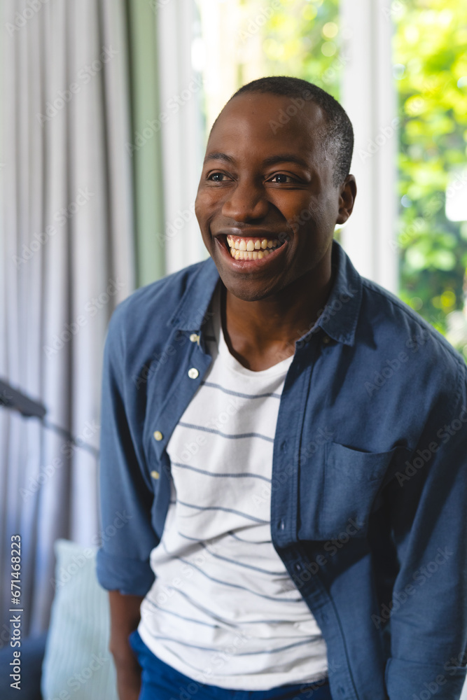 Portrait of happy african american man in bright living room at home, copy space Portrait of happy african american man in bright living room at home, copy space