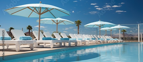 Pool Chairs with White Umbrella Beside the Swimming Pool