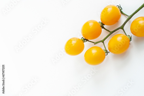 Yellow tomatoes on a white background
