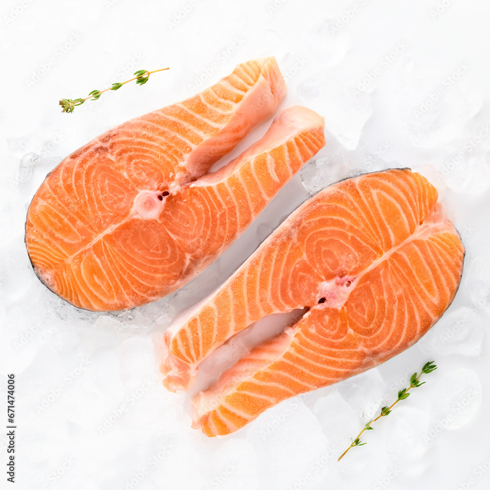 fresh salmon steaks sea fish peeled laid out on pieces of ice decorated sprig of greens isolated on white background top view for your design. healthy food. vitamins, omega b12 healthy fats for human fresh salmon steaks sea fish peeled laid out on pieces of ice decorated sprig of greens isolated on white background top view for your design. healthy food. vitamins, omega b12 healthy fats for human