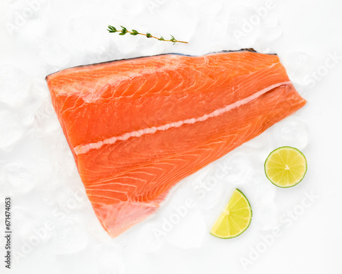 Salmon fillet sea fish peeled laid out on pieces of ice decorated with lemon sprig of greens isolated on white background top view for design. Healthy food. Vitamins, Omega B12 healthy fats