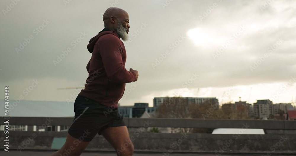 Man, city or senior runner with cardio workout in training, road fitness for health lifestyle. African athlete, retirement or wellness for strong body in leisure, cape town or exercise on urban road - obrazy, fototapety, plakaty 