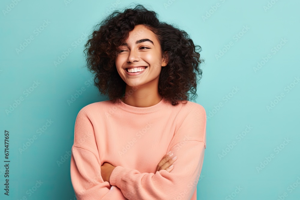 Fototapeta premium Portrait of a smiling young african american woman standing with arms crossed against blue background, ai generative