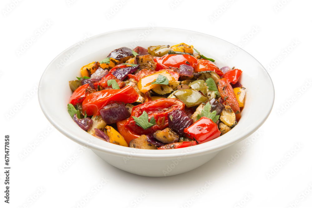Mediterranean roasted vegetables in a salad bowl isolated on white background. Mediterranean roasted vegetables in a salad bowl isolated on white background.