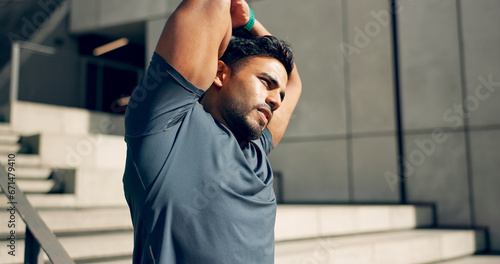 Man  athlete or stretching arms at stairs for exercise  workout or wellness outdoor by building. Urban fitness  person or warm up for power and performance with strength  training and health by steps