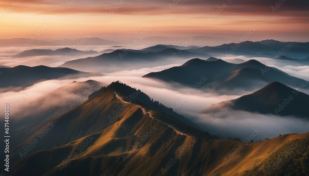 Fototapeta premium view of misty mountain layers and sunset from a high hill