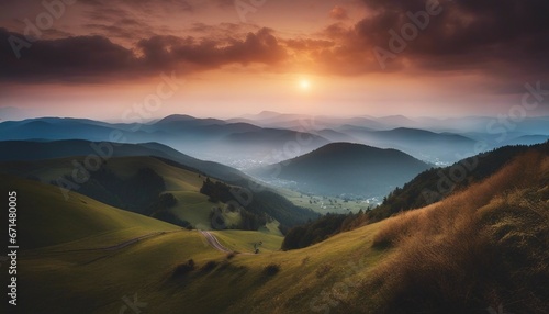 view of misty mountain layers and sunset from a high hill © abu
