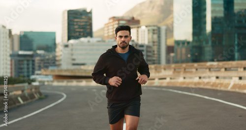 Man, morning and running in city street, road and bridge for fitness, workout and marathon training. Athlete, person or exercise in South Africa for cardio wellness, health or triathlon performance © N Felix/peopleimages.com