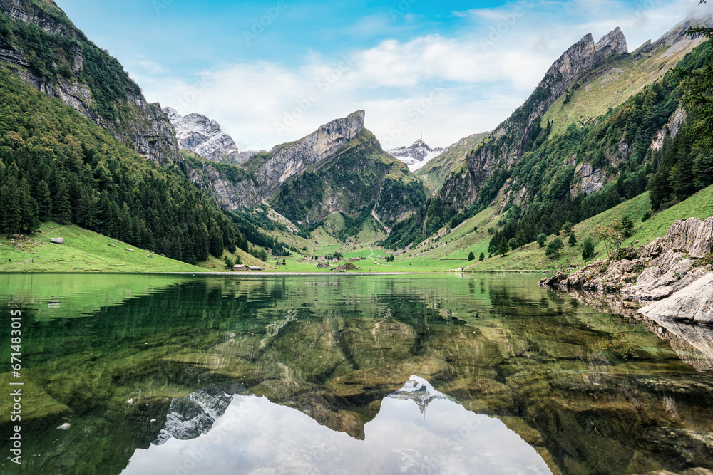 Seealpsee mountain lake reflection in Alpstein mountain range during summer at Appenzell, Switzerland