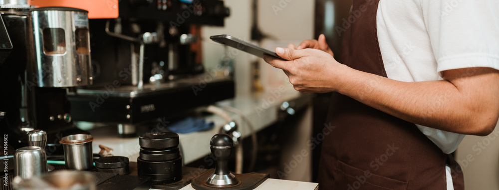 Closeup hand of Waitress use digital tablet take order service customer at coffee shop. SME business coffee shop concept. Closeup hand of Waitress use digital tablet take order service customer at coffee shop. SME business coffee shop concept.
