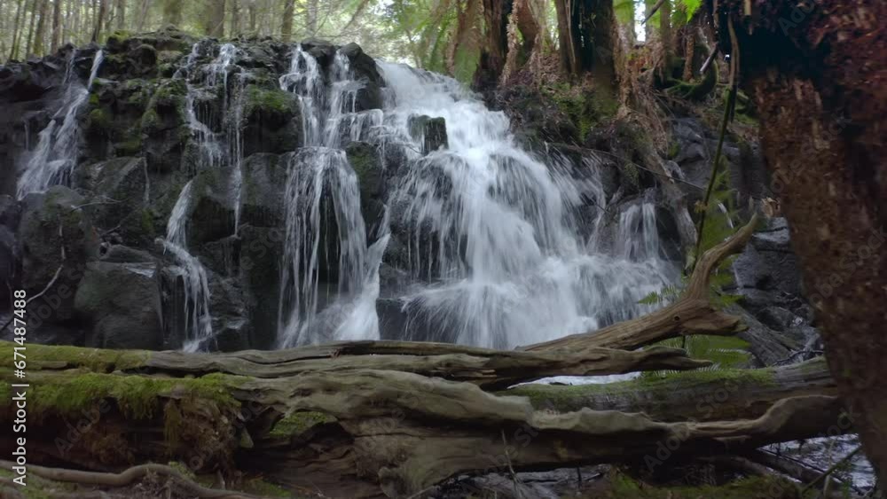 Close up view of waterfall cascade in rainforest environment Close up view of waterfall cascade in rainforest environment