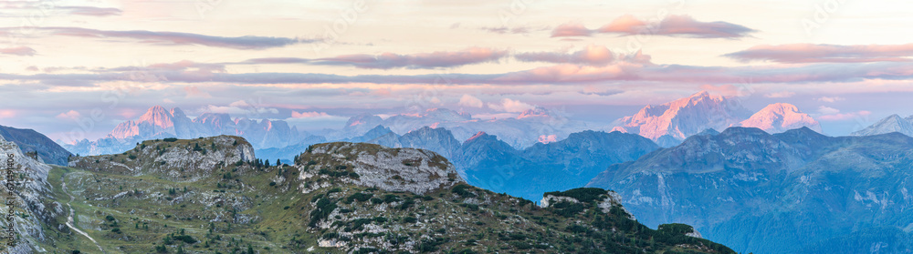 View of pink mountain peaks at sunrise from Falzarego pass, South Tyrol, Dolomites, Italy