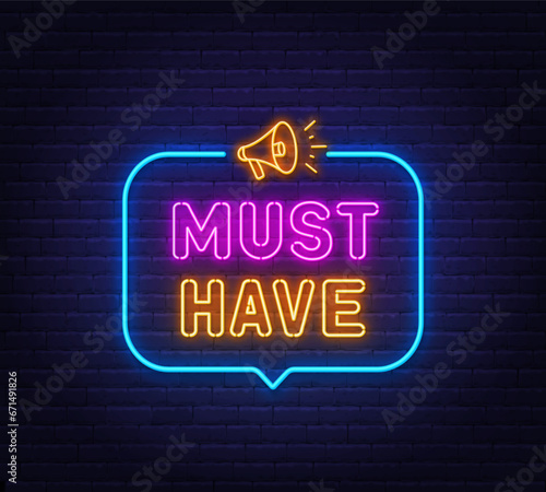 Must Have neon sign in the speech bubble on brick wall background.