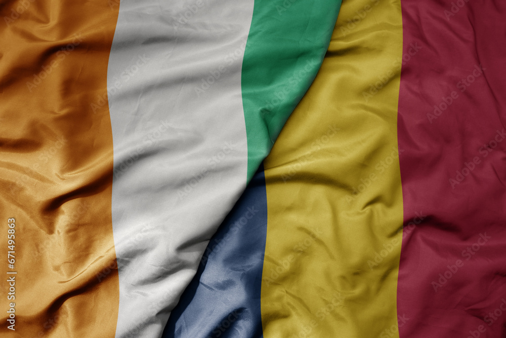 Fototapeta premium big waving national colorful flag of cote divoire and national flag of chad .