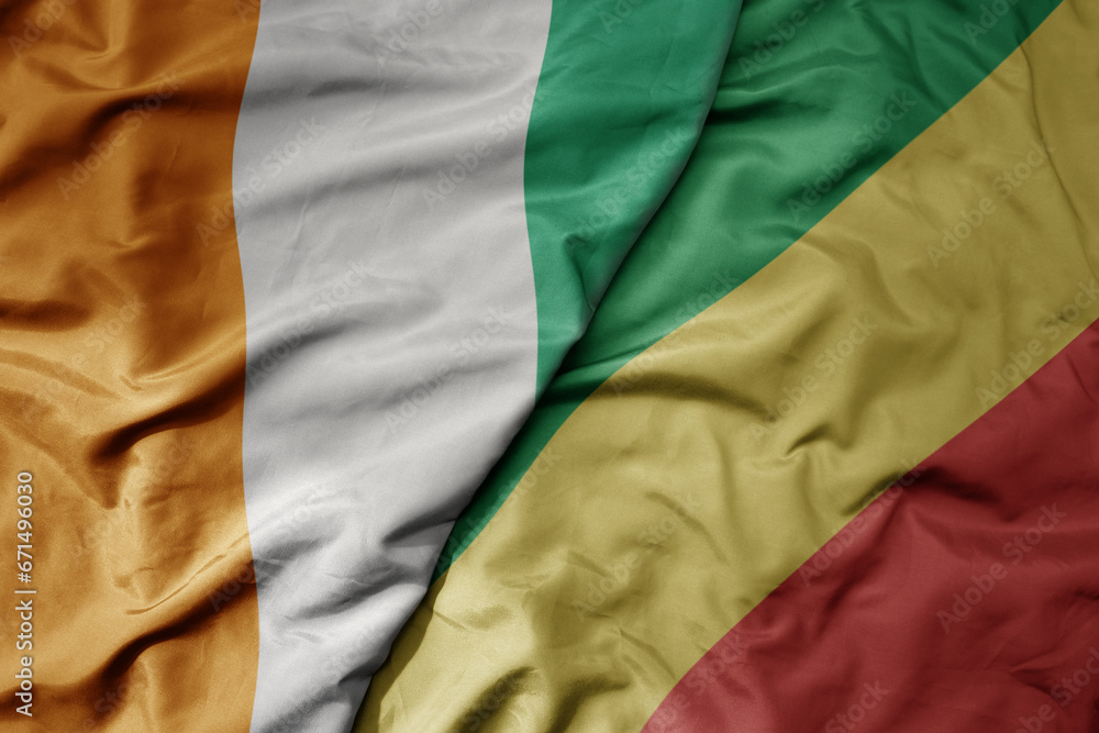 Obraz premium big waving national colorful flag of cote divoire and national flag of republic of the congo .