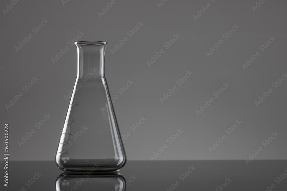 Close up of laboratory beaker and copy space on grey background Close up of laboratory beaker and copy space on grey background