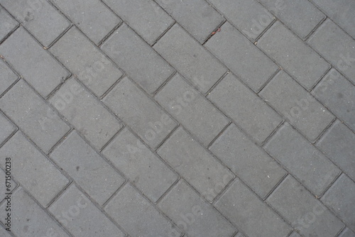 Top view of running bond brick like gray concrete pavement