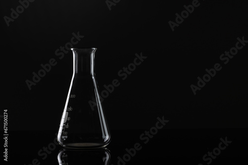 Close up of laboratory beaker and copy space on black background