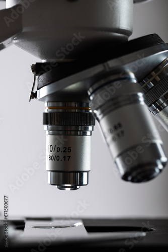 Vertical image of laboratory microscope and copy space on grey background