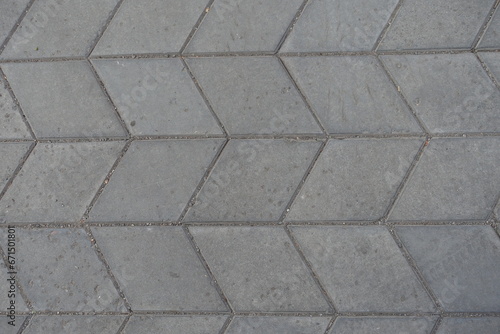 Surface of gray diamond shaped concrete pavement with geometric pattern