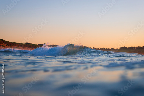 Fototapeta Naklejka Na Ścianę i Meble -  A small barrel wave in the ocean shore.