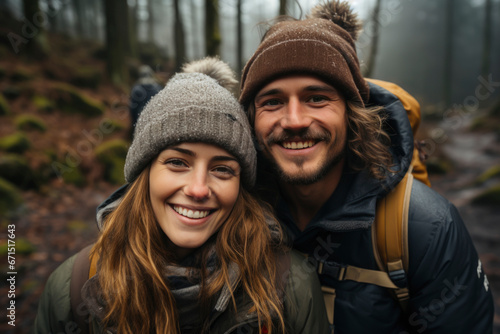 Trendy couple spending time together walking in forest in autumn.