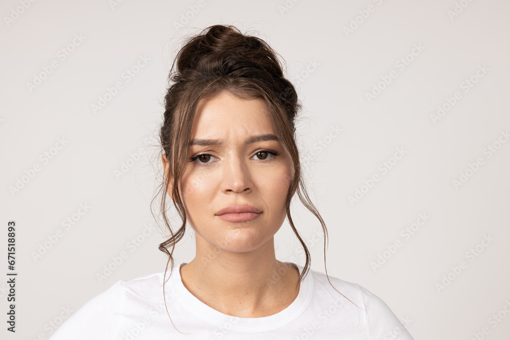 Sad young brunette woman on white background Sad young brunette woman on white background