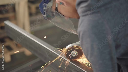 Skilled Worker Using a Grinder for Metal Cutting in Dynamic Poses and Angles, Ready for Action in the Advanced Metallurgical Industry in 4K Quality