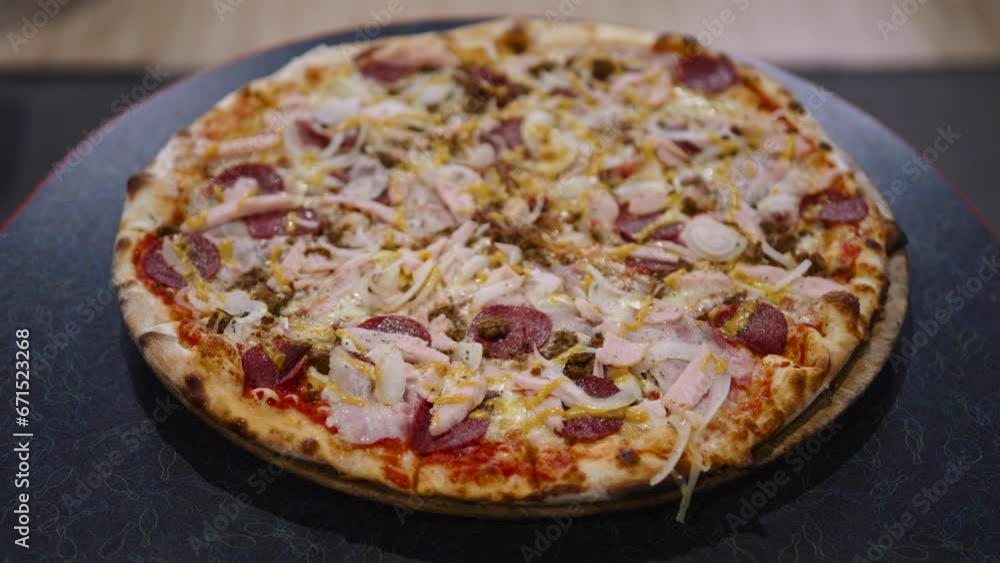 Big round delicious pizza stands on table in cheap cafe before meal. Snack for large group of friends at celebration at public food court. Pizza fresh from oven with toasted crust. Big round delicious pizza stands on table in cheap cafe before meal. Snack for large group of friends at celebration at public food court. Pizza fresh from oven with toasted crust.