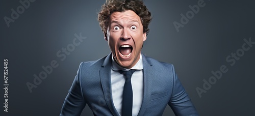 businessman screaming against solid grey color background
