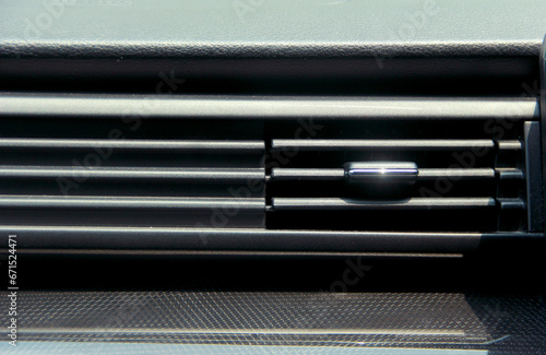 Close up of car dashboard, focused on air conditioning
