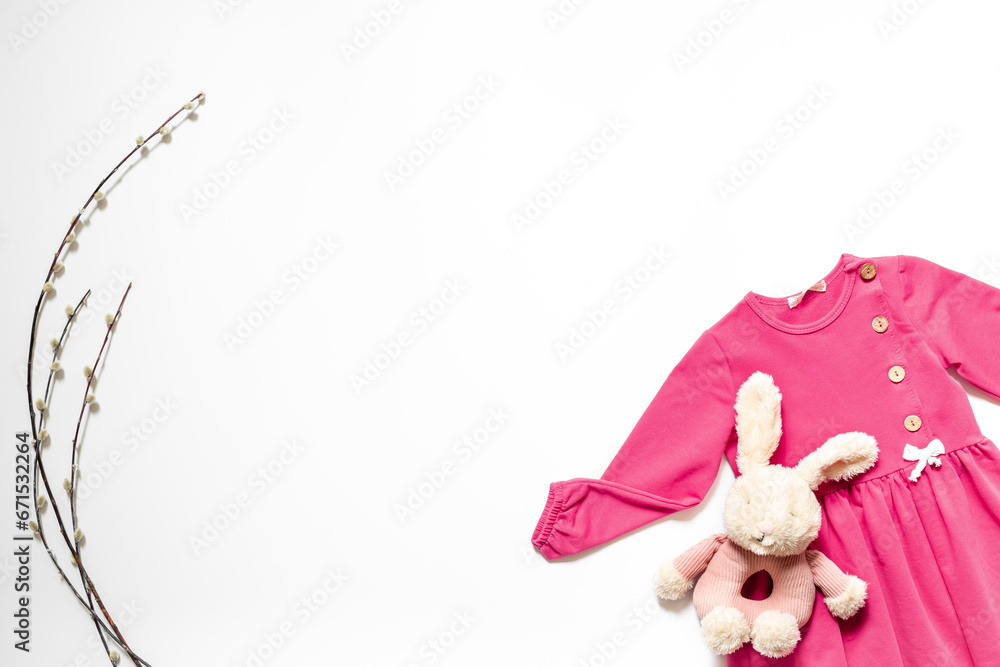 Fashion kids outfit and bunny toy. Pink dress flat lay