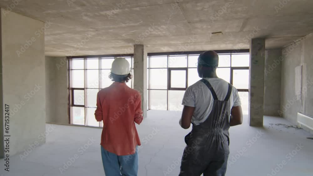 Builders talking about construction of room with panoramic windows Builders talking about construction of room with panoramic windows