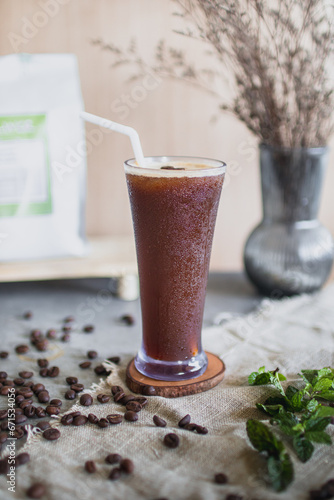 Portrait of a glass of dark stout or porter beer with coffee added. Wooden background