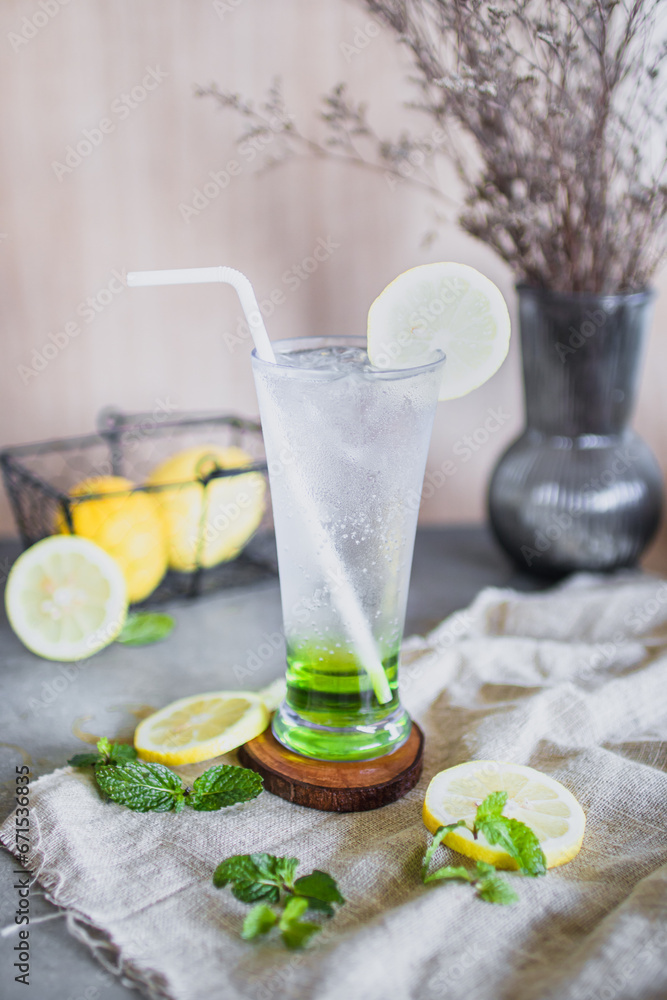 Freshly squeezed sweetened lemonade on ice on women hand Freshly squeezed sweetened lemonade on ice on women hand