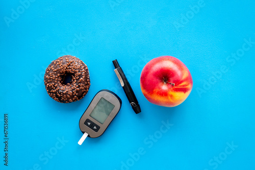 Blood glucose meter and food. Checking blood sugar level. Diabetes concept