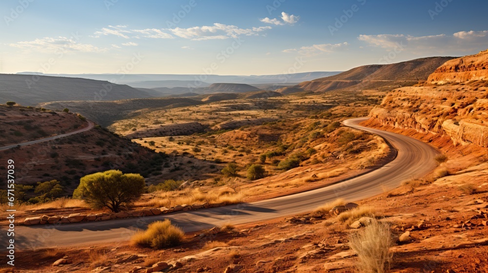 A winding road through a desert landscape with mountains