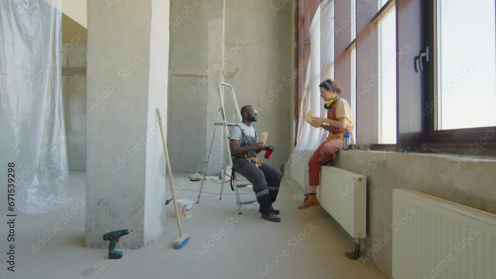Construction workers having lunch break at workplace Construction workers having lunch break at workplace