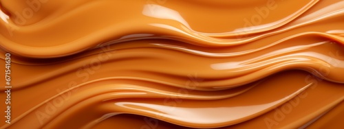 Liquid salted caramel syrup. Background of caramel paste. Texture Close up, top view. photo