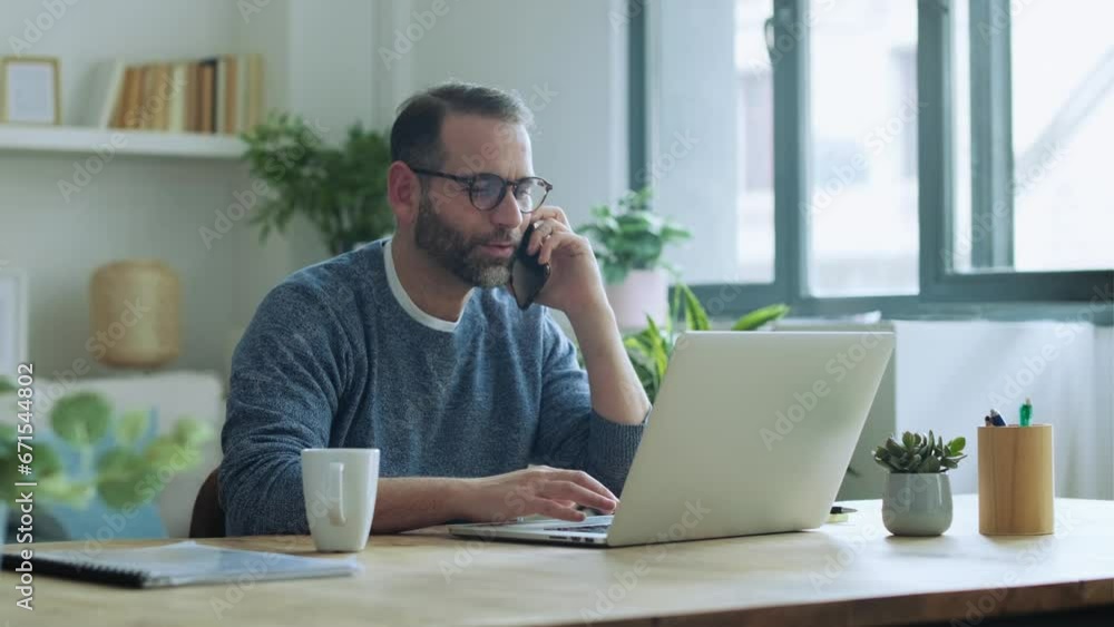 Businessman sitting at desk working on laptop drinking coffee Businessman sitting at desk working on laptop drinking coffee