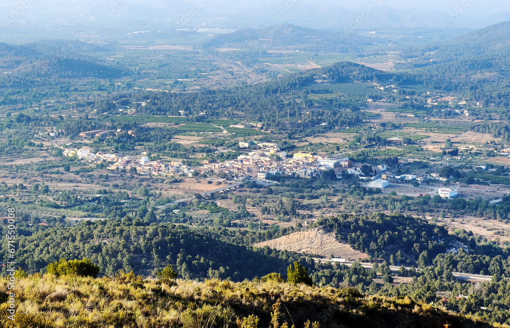 Houses at Gilet Town in mountains. Urbanization with houses and homes in mountains hills. View on city from mountain. Rural landscape with hills. Spain mountains landscape in Sierra Calderona park.