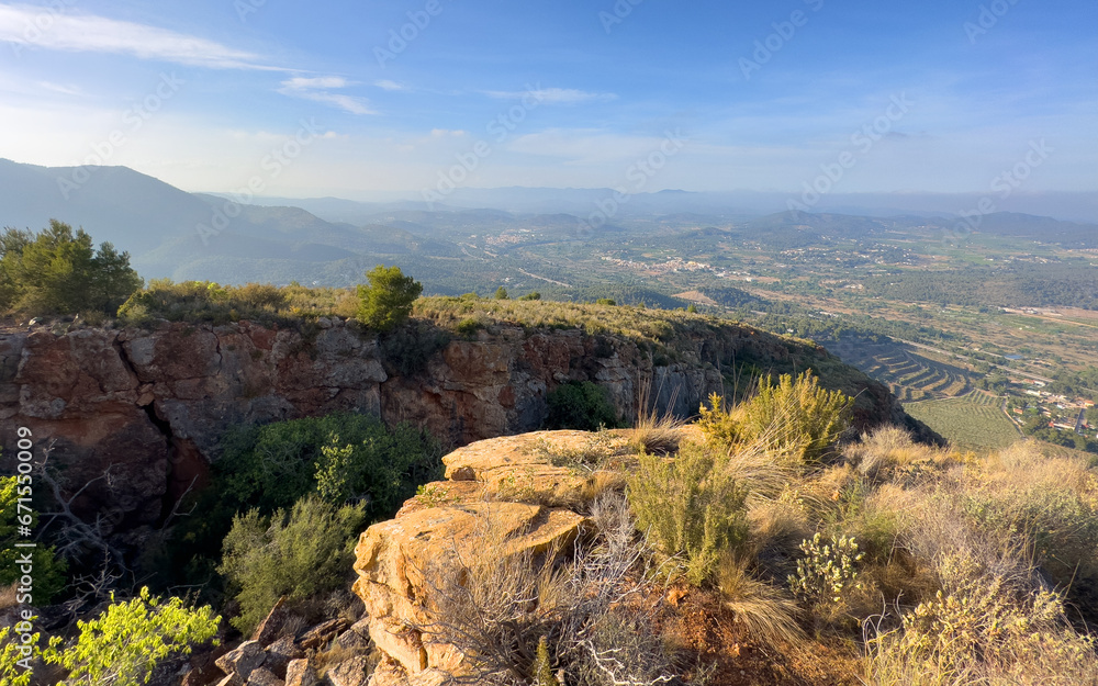 Mountains landscape, nature scenery. Green trees and huge cobblestones in mountain rock. View from Peak of La Redona mountain range in Sierra Calderona, Spain. Landscape of a mountain valley.