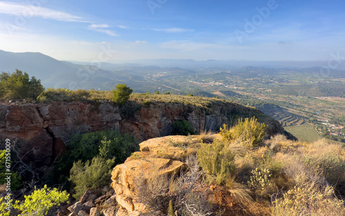 Mountains landscape, nature scenery. Green trees and huge cobblestones in mountain rock. View from Peak of La Redona mountain range in Sierra Calderona, Spain. Landscape of a mountain valley.