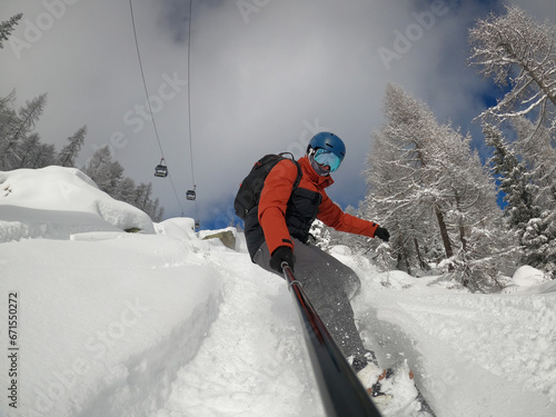 Man riding in powdre on snowborad. Freeride powder, snowboarding in alpes resort in winter. Snowboard freeride i deeep powder snow. Freeride winter in dolomites photo