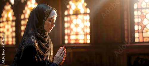 Inside the mosque  a young Asian woman in a hijab and traditional clothing offers her devout prayer to Allah
