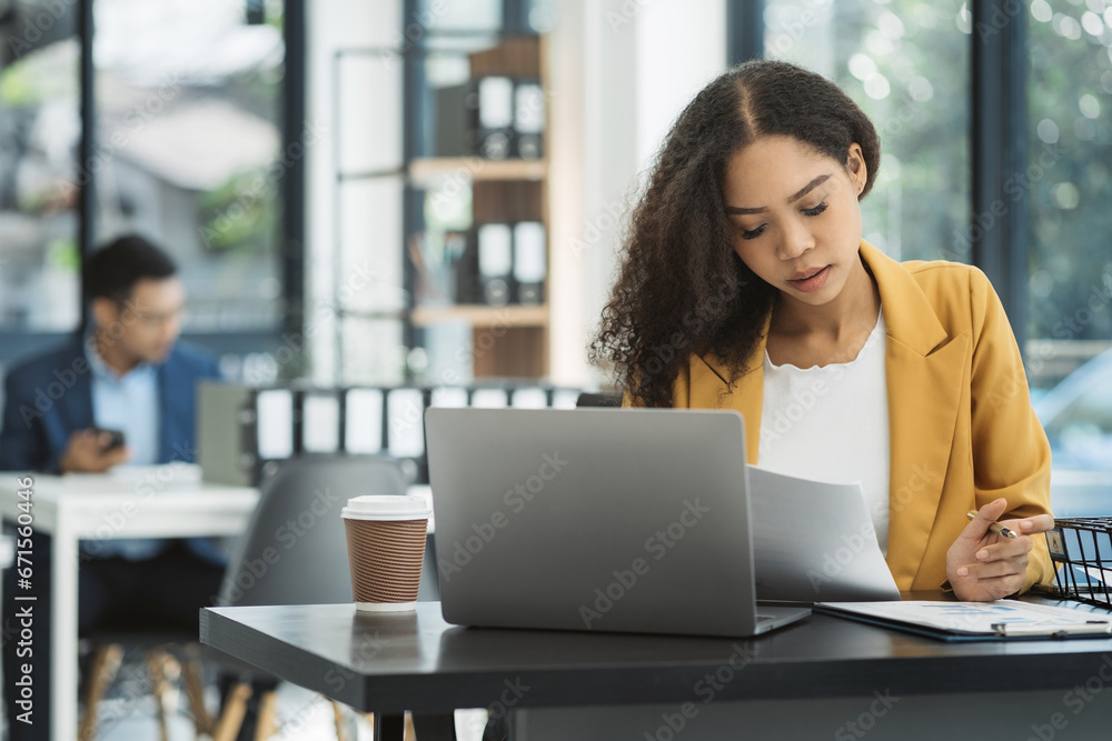 Serious businesswoman concentrating on his paper work at the table at office. Serious businesswoman concentrating on his paper work at the table at office.