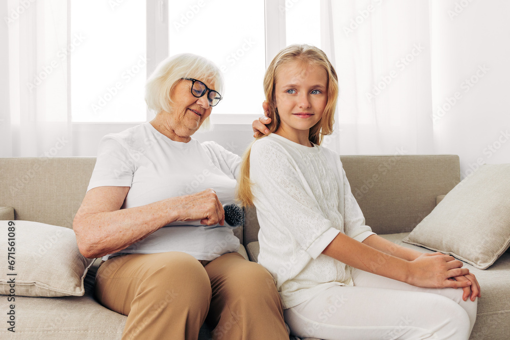 Woman girl comb couch child family sofa love happy granddaughter home grandmother Woman girl comb couch child family sofa love happy granddaughter home grandmother