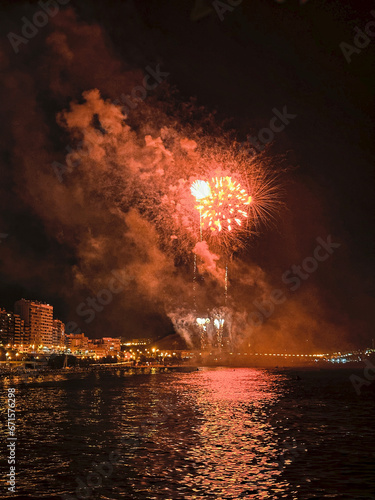 colorful fireworks in the night sky on the seafront of Alicante spain © Joanna Redesiuk