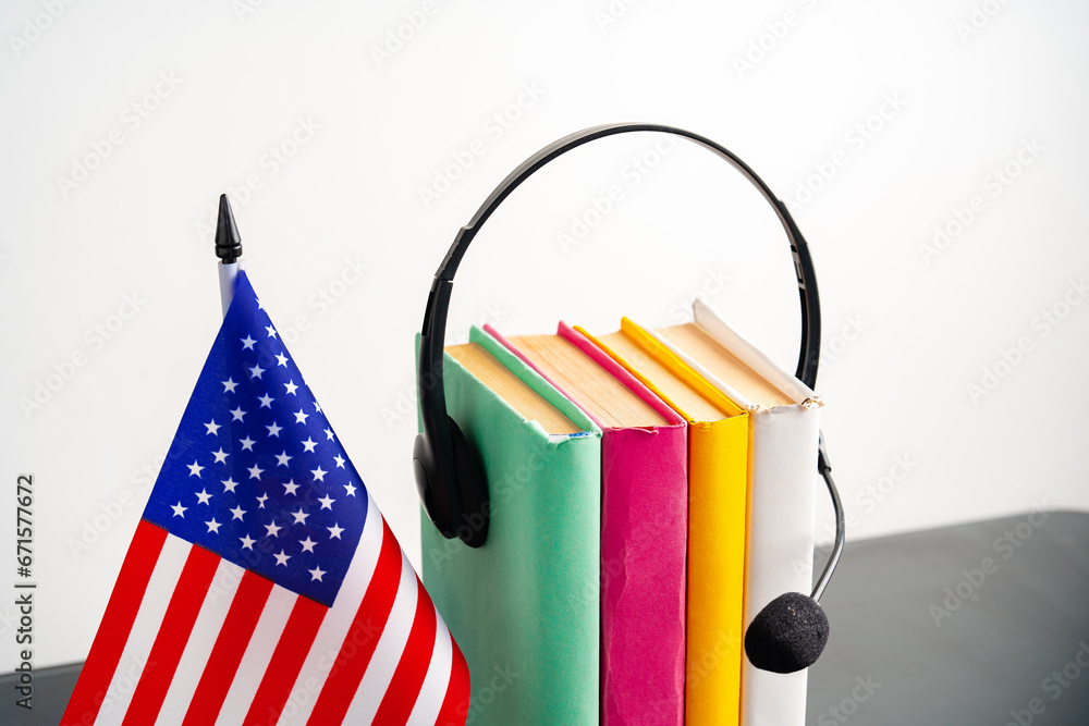 Obraz premium USA flag with pile of books against white background
