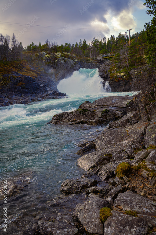 Stuttgongfossen, a powerful waterfall south of Vagamo, located at Hindsæte/Sjodalen in the region Oppland, Norway. Stuttgongfossen, a powerful waterfall south of Vagamo, located at Hindsæte/Sjodalen in the region Oppland, Norway.